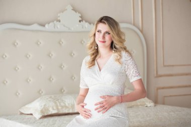 Evde çekici hamile bir kadın var.