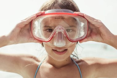 Maskeli küçük kız denize daldı.