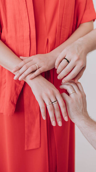 beautiful hand of a girl with a ring on her finger in a red dress