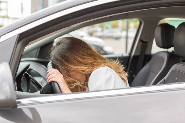 Frustrated young woman stuck in a traffic jam