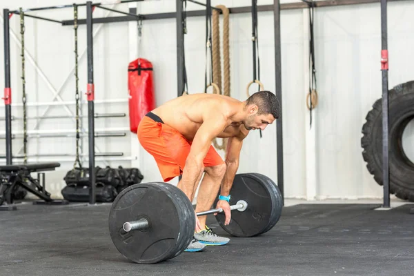 Kale rondborstige man Gewichtheffen barbell in de sportschool — Stockfoto