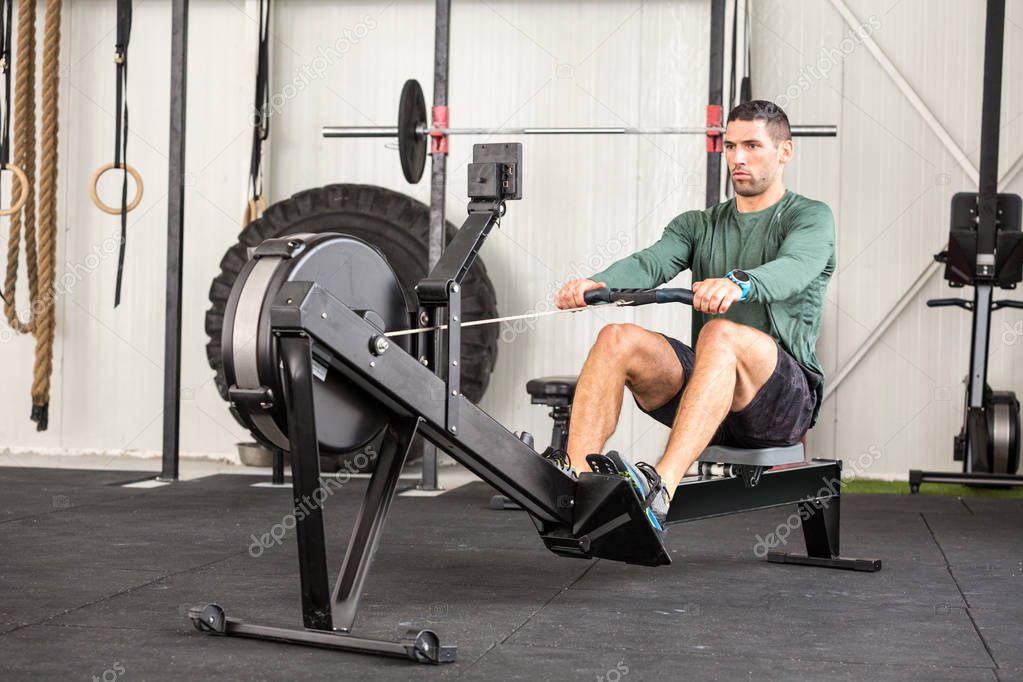 Man using rowing machine in a gym