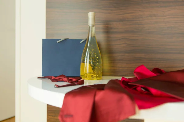 Bottle of wine with edible gold in hotel room