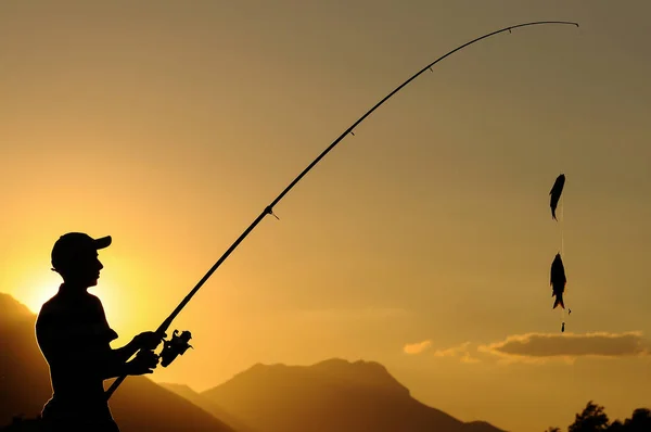 lucky young man fishing with a fishing rod