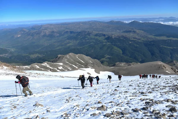 climbing activity, trekking and crowded mountaineering group