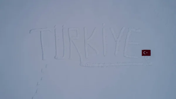 writing and flag turkey on the snow