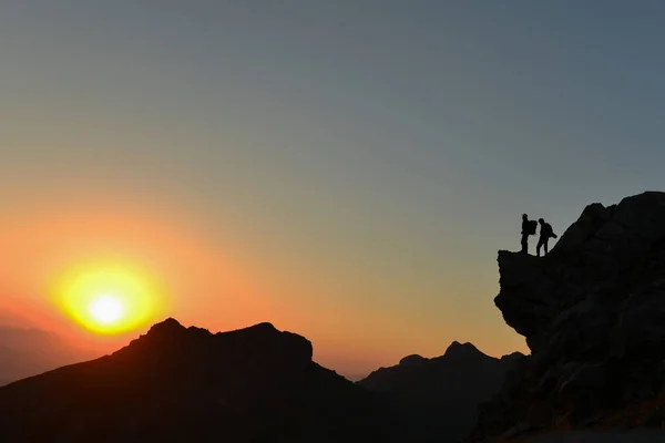 Bergsteiger auf dem Gipfel folgten dem Sonnenaufgang und stolz aufrecht — Stockfoto