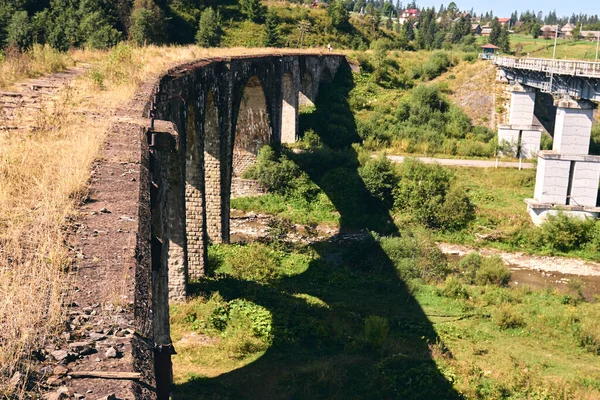 Panorama view of ancient bridge. Old railway viaduct in the mountain resort village of Vorokhta. Ukraine, Carpathians. Locat travel concept.