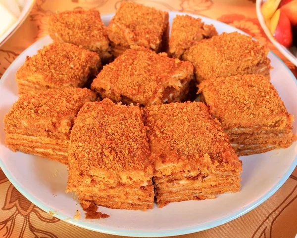 Honey cake with custard chopped on a plate