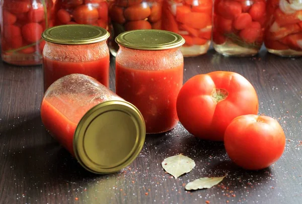 Canned tomatoes for the winter in banks. Tomato salads with vinegar.