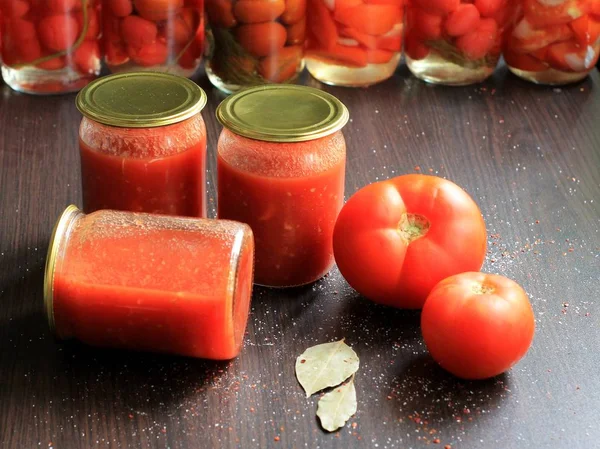 Canned tomatoes for the winter in banks. Tomato salads with vinegar.