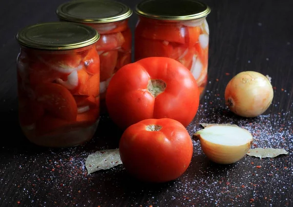 Canned tomatoes for the winter in banks. Tomato salads with vinegar.