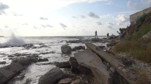 Морской Люди Смотрят Закат Море Волны Разбиваются Брызгаются Скалы Морском — стоковое видео