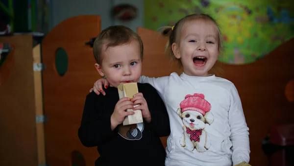 Grappig jongetje en meisje drinken samen sap op de kleuterschool — Stockfoto