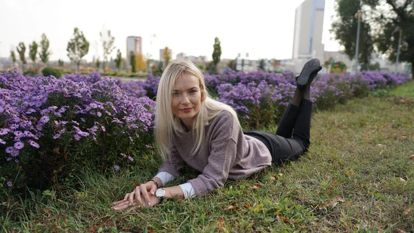 Schöne lächelnde blonde Frau im Wollpullover im Herbstpark — Stockfoto