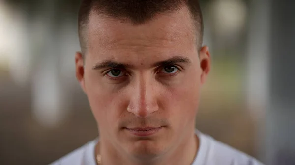 Close-up portrait of a strong young man with confident and intent look