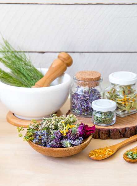 Lot of different dry herbal remedy plants( Chamaenerion angustifolium, Achillea millefolium, Tilia platyphyllos, Prunella vulgaris, Equisetum arvense, calendula officinalis in containers.