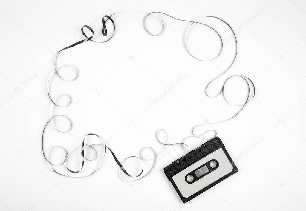 Analogue cassette tape on white background, 80s retro frame, lot of empty copy space. 