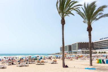Alicante, İspanya; 08 Temmuz 2020; Güneşli bir yaz gününde güneşlenen ve yüzen insanlarla dolu Postiguet plajı