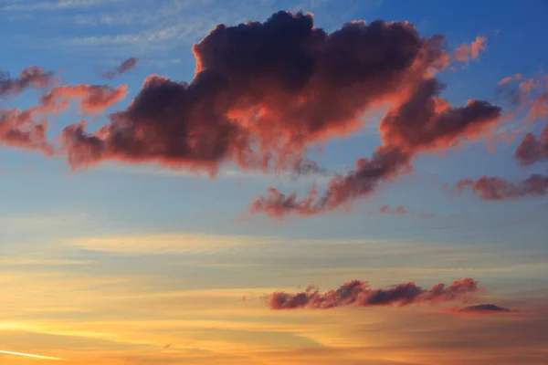 Dramatic red clouds against a blue-orange sky