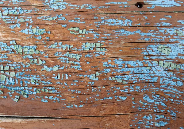 Old wooden background with remains of pieces of scraps of old paint on wood. Texture of an old tree, board with paint, vintage background peeling paint. old blue board with cracked pain — Stock Photo, Image