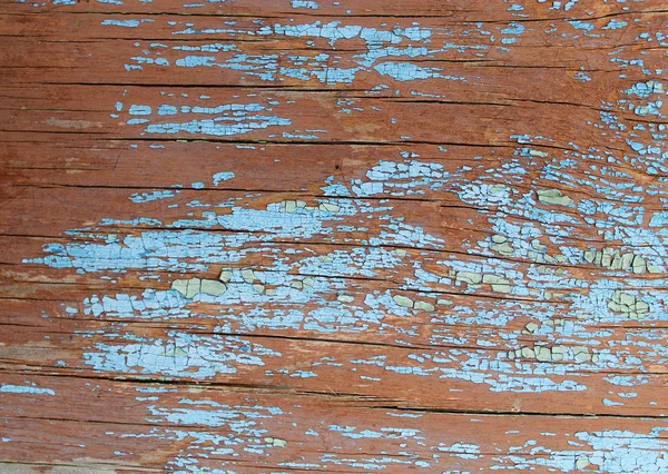 Fundo de madeira velho com restos de pedaços de restos de tinta velha em madeira. Textura de uma árvore velha, placa com tinta, fundo vintage descascando tinta. placa azul velho com dor rachada — Fotografia de Stock