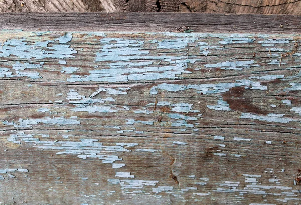 Vecchio sfondo in legno con resti di pezzi di scarti di vecchia vernice su legno. Struttura di un albero vecchio, asse con vernice, vernice di peeling di sfondo d'annata. vecchio bordo blu con vernice incrinata, annata, woo — Foto Stock