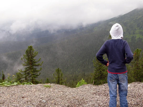 Mystic fog in mountains boy standing alone