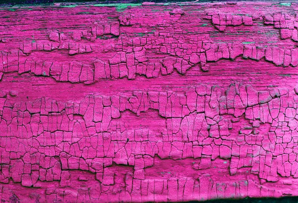 Gammal trä bakgrund med rester av bitar av rester av gammal färg på trä. Textur av ett gammalt träd, vintage trä bakgrund skalning färg. gammal blå bräda med sprucken färg — Stockfoto