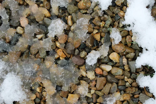 spring snow on the rocks. snow patterns, textured