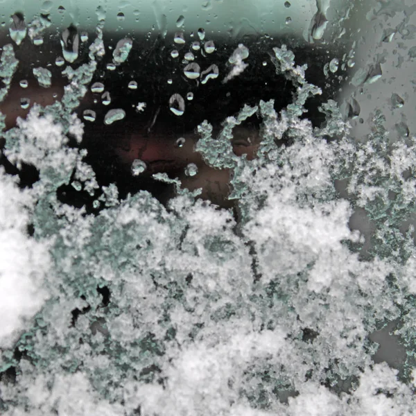 Melting snow on the glass. sleet on glass — Stock Photo, Image