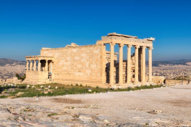 Ancient Erechtheion temple with Caryatid Porch on the Acropolis near Parthenon, Athens, Greece.