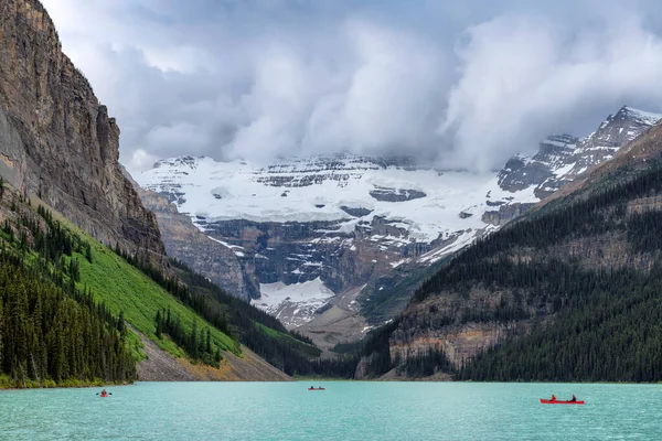 Storm in Lake Louise with snowfall in mountains in summer, Rocky Mountains, Banff National Park, Canada.
