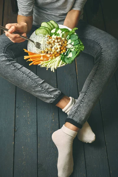 woman having Healthy breakfast, raw vegan food in Buddha Bowl