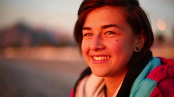 Young woman meeting dawn on the sea beach — Stock Video