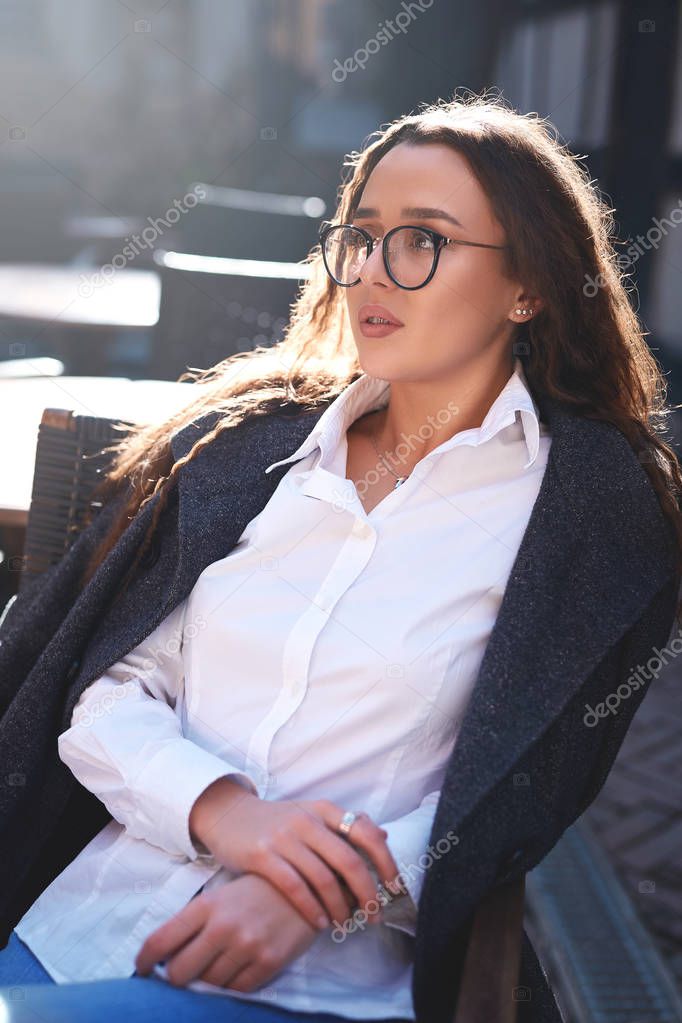 beautiful woman sitting in the street cafe
