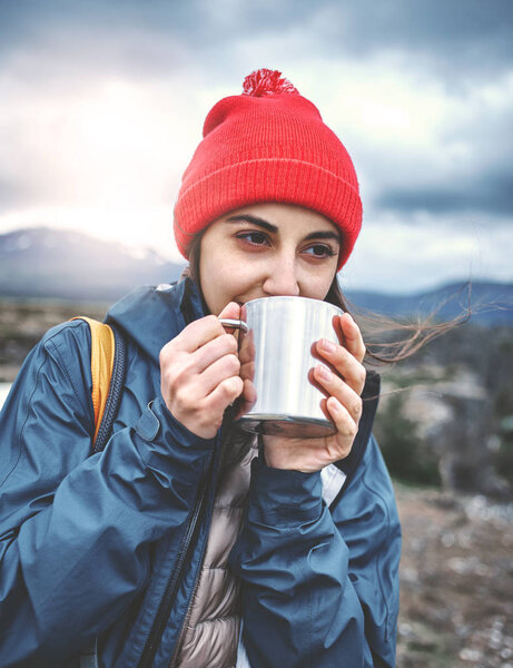 Cheerful woman drink tea on nature
