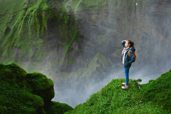 Cheerful woman walking and posing on nature in Iceland
