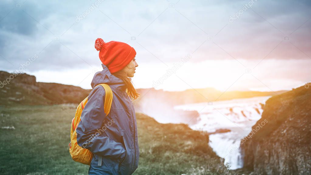 Cheerful woman walking and posing on nature in Iceland
