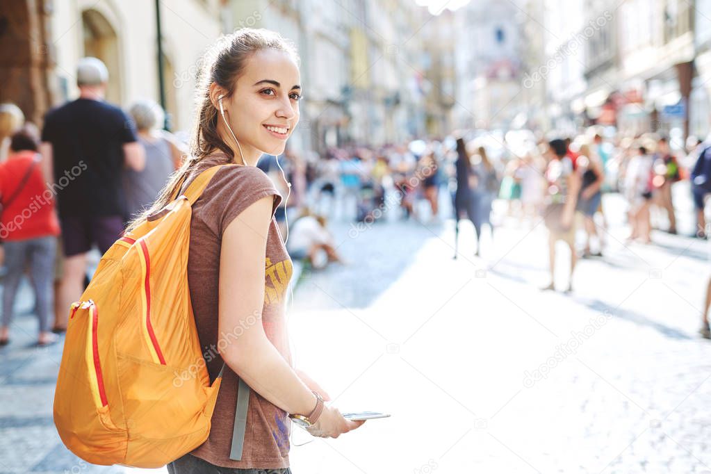 a woman tourist in the center of Prague with a phone in the hands of