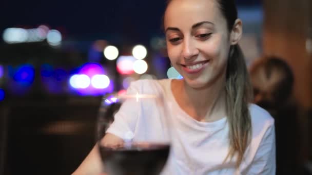 Woman offers a glass of red wine, first person view — Stock Video