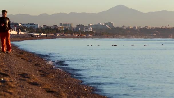 Vista da praia pública e mar calmo ao nascer do sol em Antalya, Turquia . — Vídeo de Stock