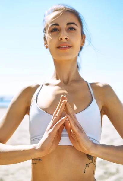Молода досить усміхнена жінка розслабляється практикує йогу і медитацію на піщаному пляжі в спекотний сонячний літній день . — стокове фото
