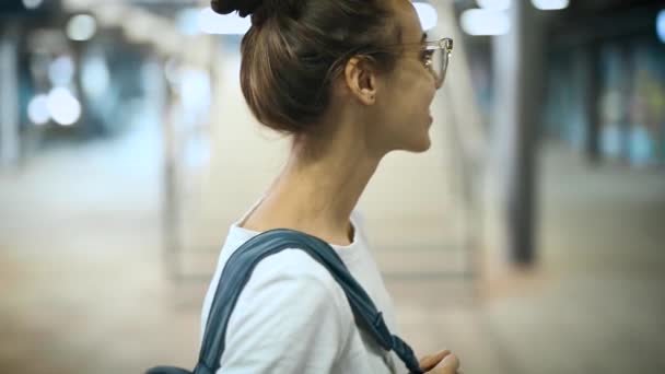 Primer plano retrato de joven sonriente mujer hermosa de moda en gafas transparentes posando al aire libre. cámara lenta — Vídeo de stock