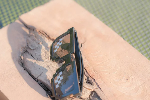 Thug life pixel model sunglasses shoot outside closeup. Selective focus
