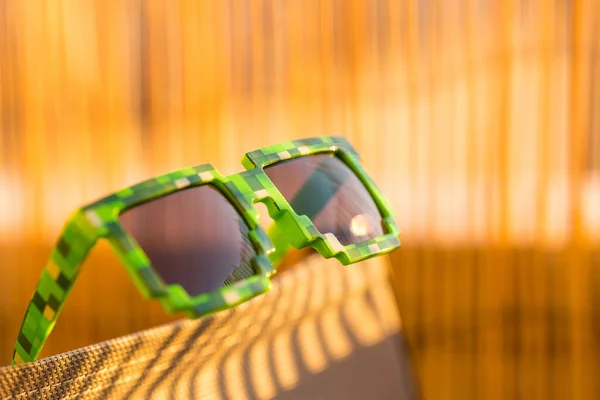 녹색 후드 라이프 픽셀 모델 선글라스는 맑은 날 클로즈업으로 밖에서 촬영 한다. 선택적 초점 — 스톡 사진
