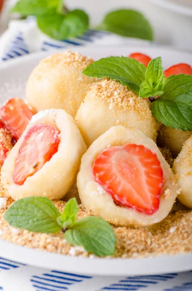 Stuffed strawberry dumplings, delish dessert with herbs, food photography