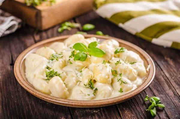 Cheese gnocchi with blue cheese sauce and galic, herbs on top, delish food