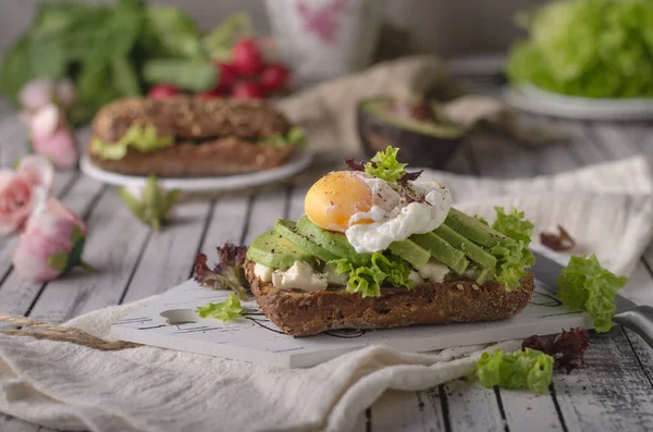 Homemade avocado poached egg sandwich wholegrain bread, food photography