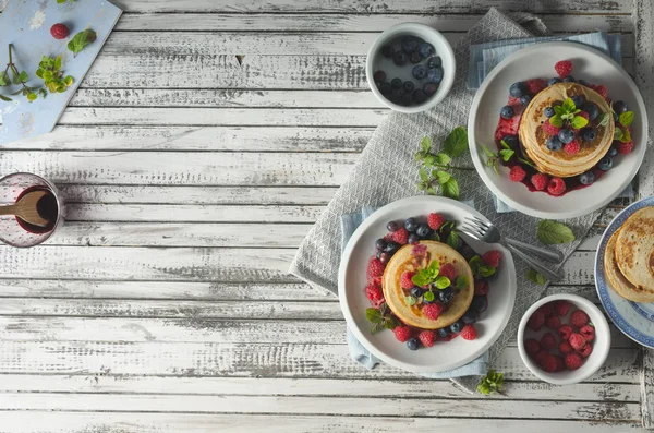 Pancakes with forest fruit sauce